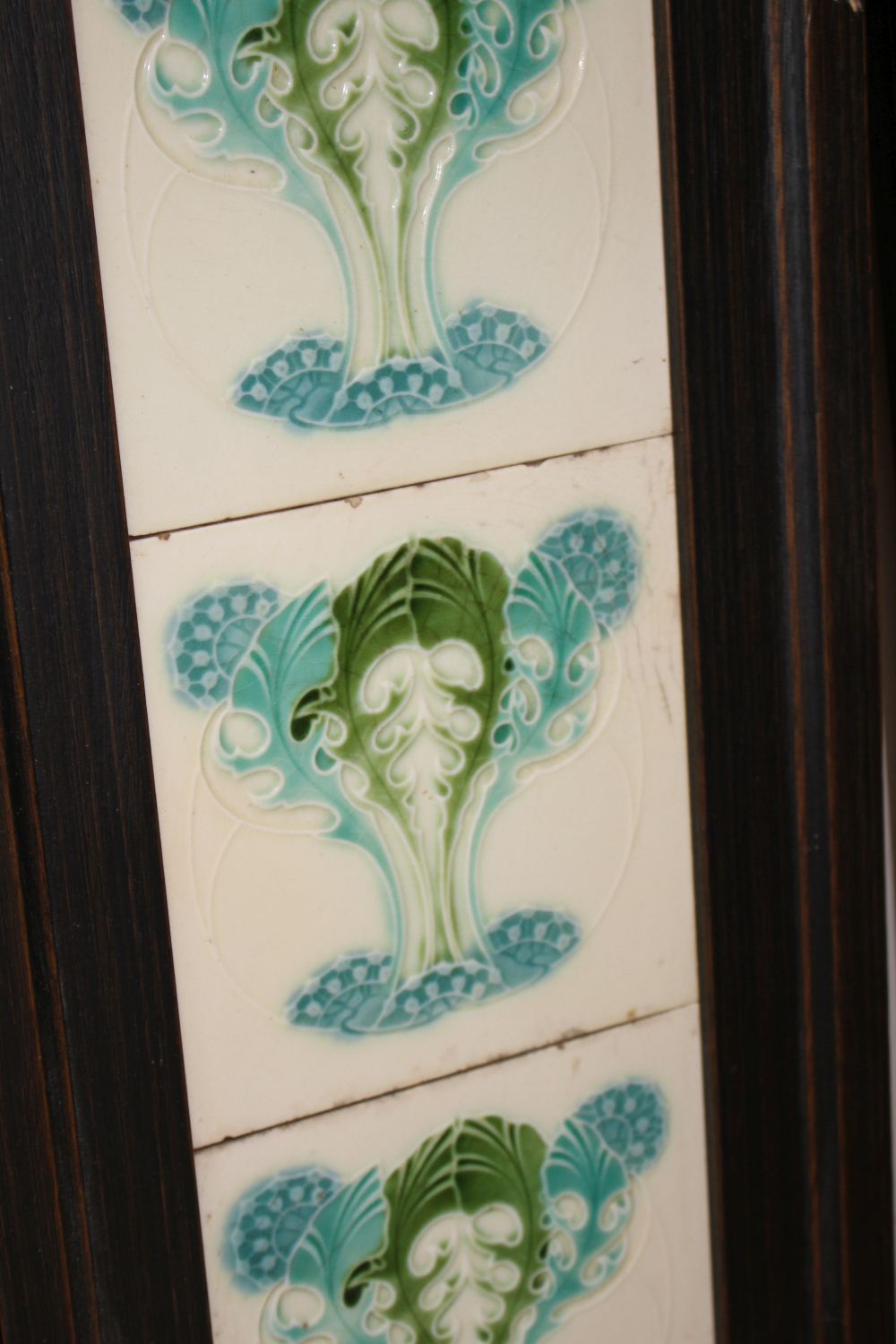 A pair of Victorian apple blossom tile panels and a set of six Art Nouveau foliate design tiles, all framed